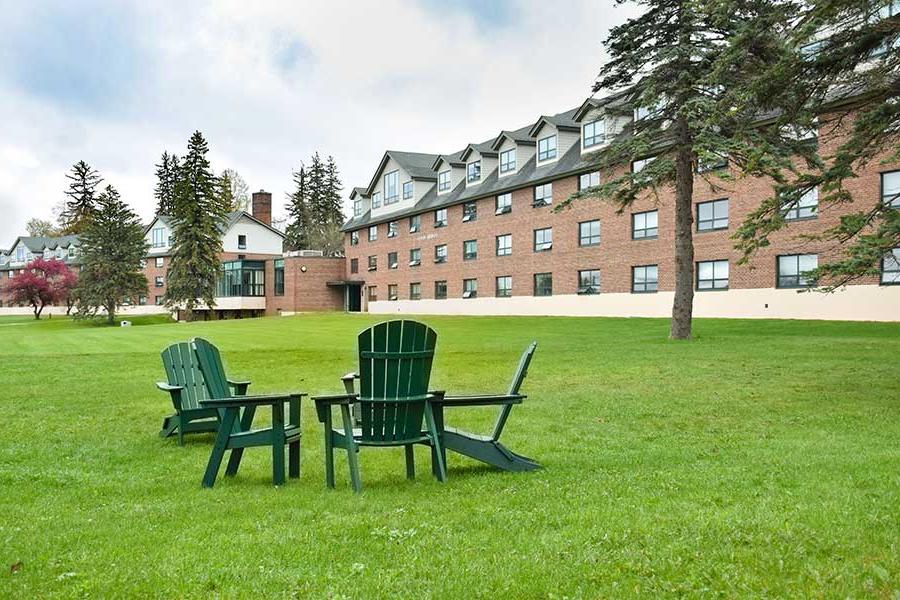Adirondack chairs in front of the dorms